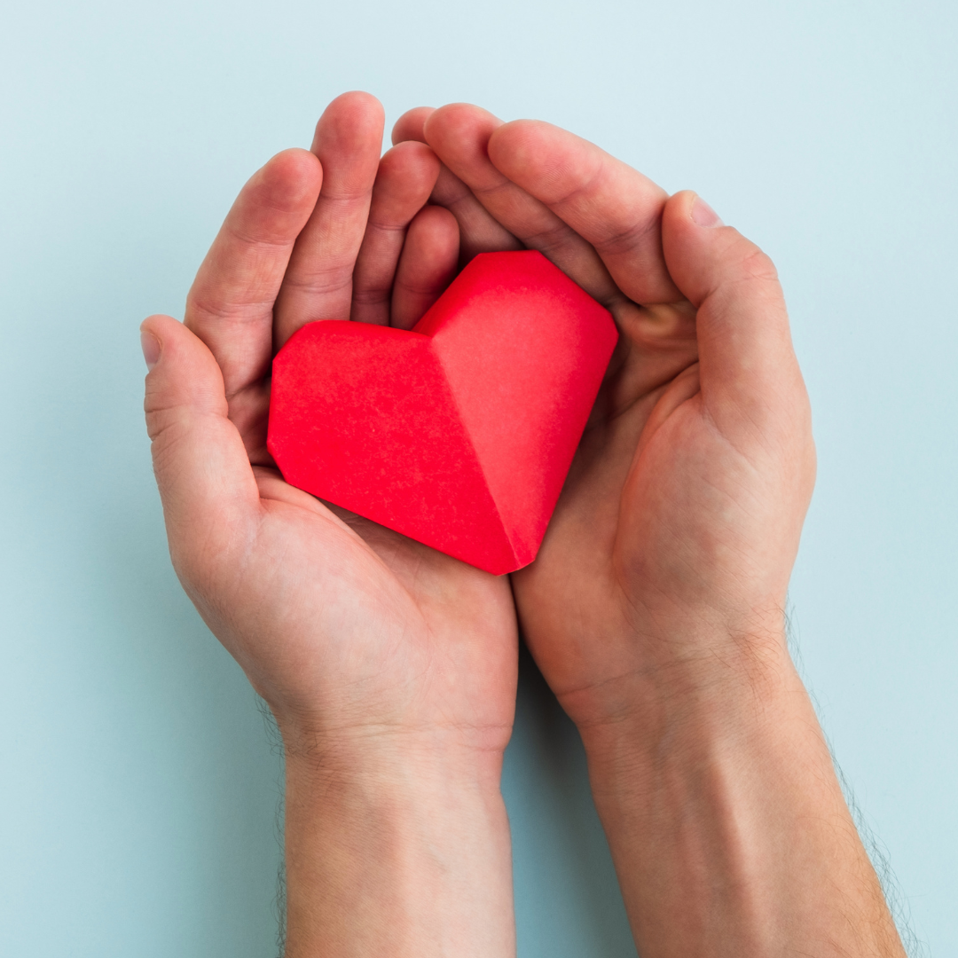 Paper heart in hands Paper heart in hands